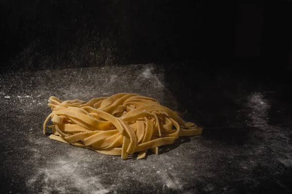 Fresh italian uncooked homemade pasta. Hands making pasta. Spaghetti. Fresh italian spaghetti. Closeup of process of making cooking homemade pasta. Chef make fresh italian traditional pasta — Stock Photo, Image