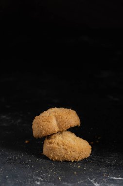 Koyu taş arka plandaki çerezlerin görünümünü kapatın. Tatlı fırın coockie gıda. Kahve veya çay için tatlı. Ev yapımı yemekler. Metin, logo için ücretsiz kopyala yapıştır alanı