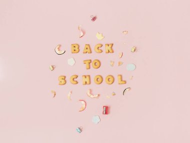 Çerezler üzerinde pastel pembe renkli arka plan ile yazı okula geri yapılmış