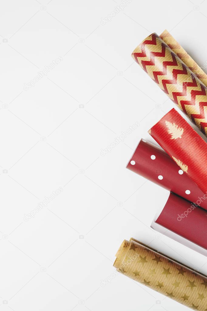 Close view of colorful christmas collection of wrapping paper for gifts on white background