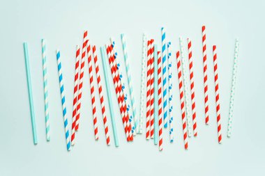 Pastel mavi arka planda içecek için içme pipet yığını