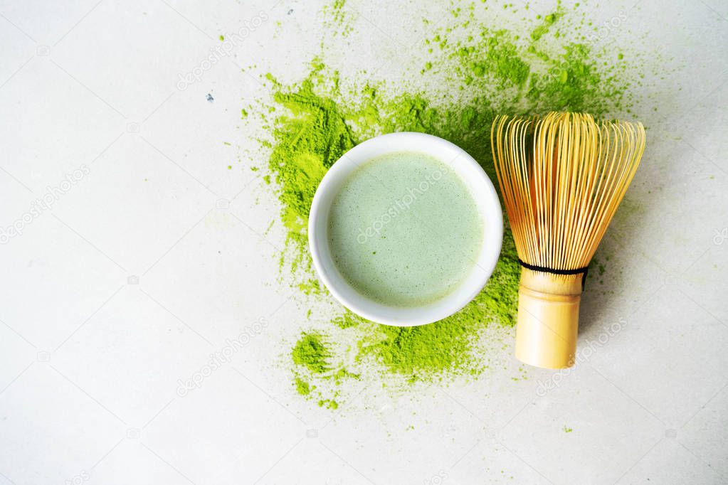 Organic green tea Matcha powder with chasen bamboo whisk, bowl for brewing on light background