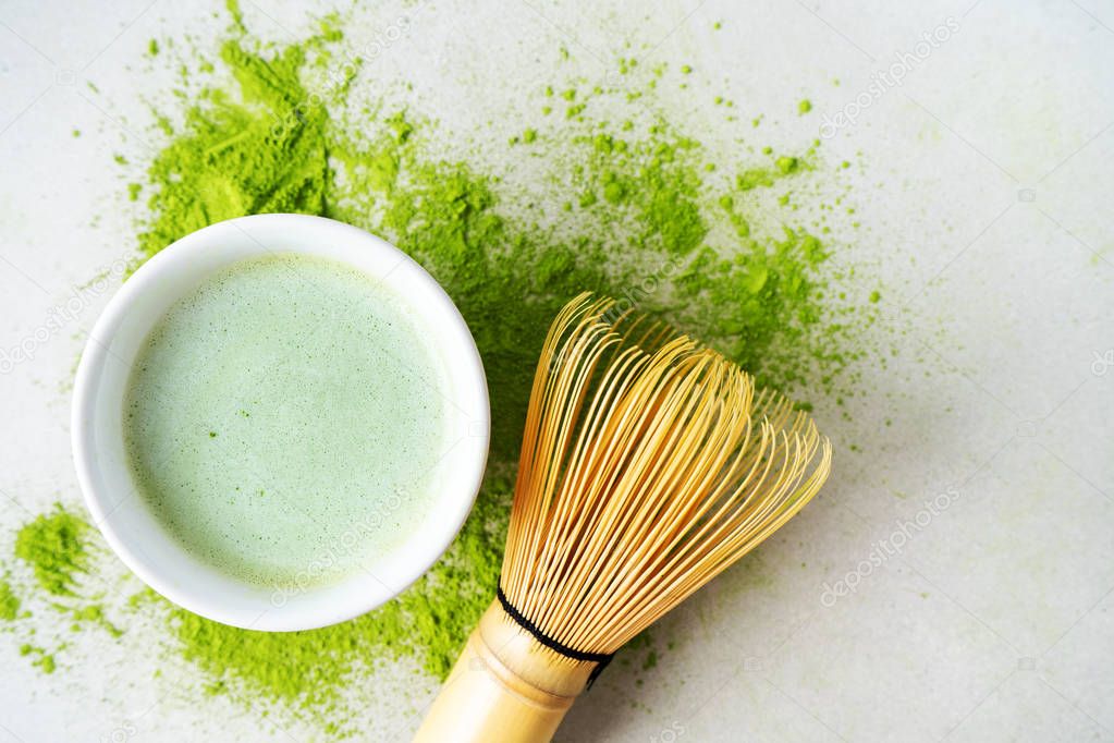 Organic green tea Matcha powder with chasen bamboo whisk, bowl for brewing on light background