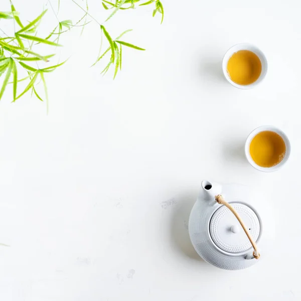 Two White Cups Tea Teapot Surrounded Green Leaves White Background — Stock Photo, Image