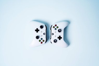 Two XBOX gamepads controller joysticks on blue pastel background  clipart