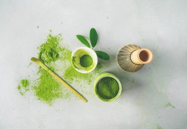 Chasen bambu çırpıcı ile Organik yeşil çay Matcha tozu, hafif arka plan üzerinde demlemek için kase