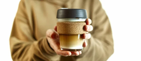 女性の手はコーヒーを取るための再利用可能な旅行用ガラスマグカップを保持します 環境に配慮したコンセプト 廃棄物ゼロ 持続可能なライフスタイルコンセプト — ストック写真