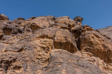 A rock cliff with the pre-islamic inscriptions at the north entrance of Wadi Massal, Riyadh Province, Saudi Arabia