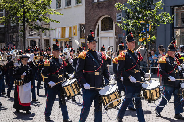 Military orchestra in traditional ceremonial uniform performing and marching in parade on the 2018 Veterans' Day in The Hague