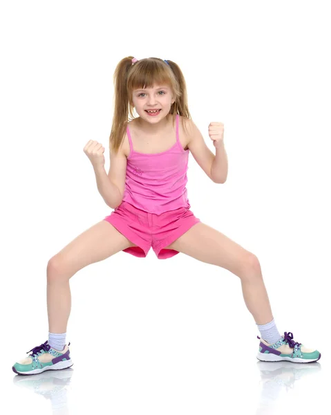 Una bambina mostra i muscoli . — Foto Stock