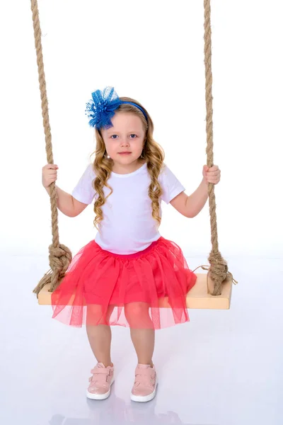 Little girl swinging on a swing — Stock Photo, Image