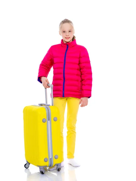 The girl gymnast with a large suitcase goes to the competition. — Stock Photo, Image