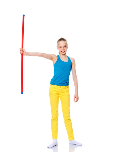 Girl gymnast holding a stick in her hand. — Stock Photo, Image