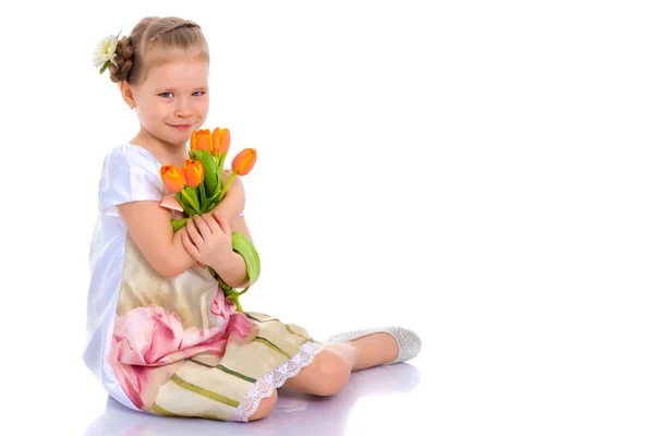 Little girl with a bouquet of flowers — Stock Photo, Image