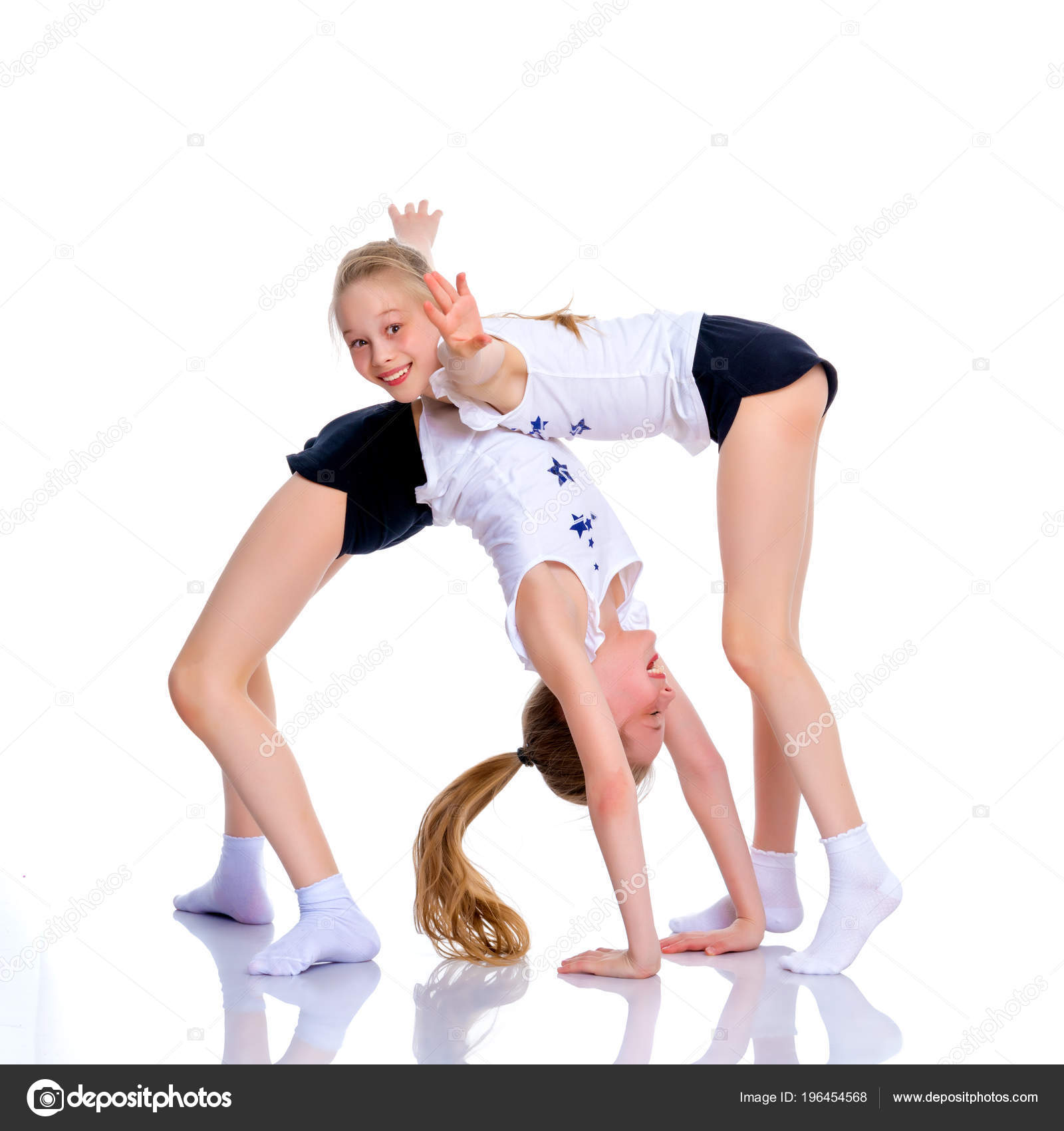 Girls gymnasts perform exercises. — Stock Photo © lotosfoto1 #196454568