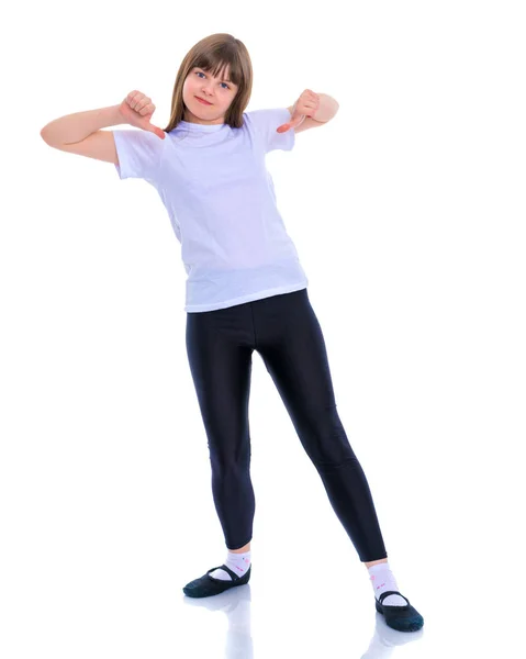 Маленькая школьница указывает на свою пустую белую футболку . — стоковое фото