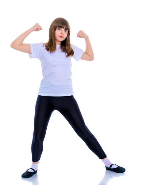 A little girl shows her muscles. — Stock Photo, Image