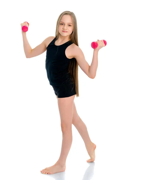 Teenage girl with dumbbells in hands — Stock Photo, Image