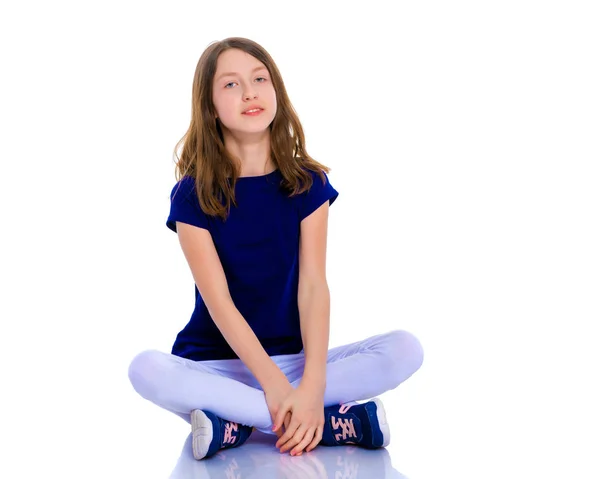 Little girl is sitting on the floor. — Stock Photo, Image