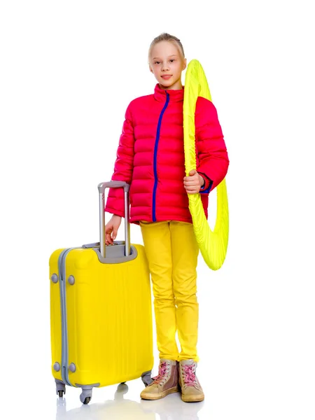The girl gymnast with a large suitcase goes to the competition. — Stock Photo, Image