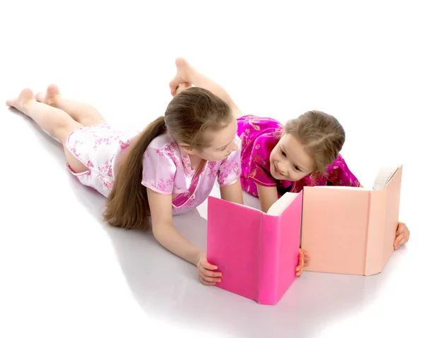 Sister girls read a book. — Stock Photo, Image