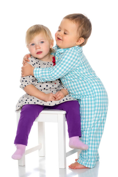 Babies boys and a girl cute embrace.