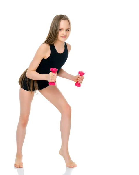 Teenage girl with dumbbells in hands — Stock Photo, Image
