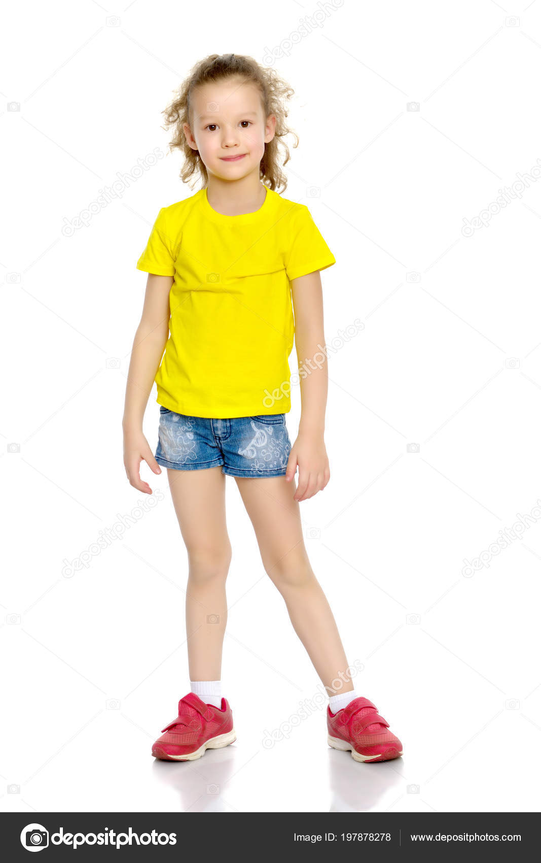 A nice little girl in shorts and a vest. Stock Photo by