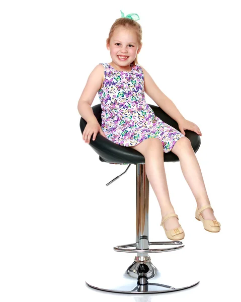 Malá holčička se sedí na židli — Stock fotografie