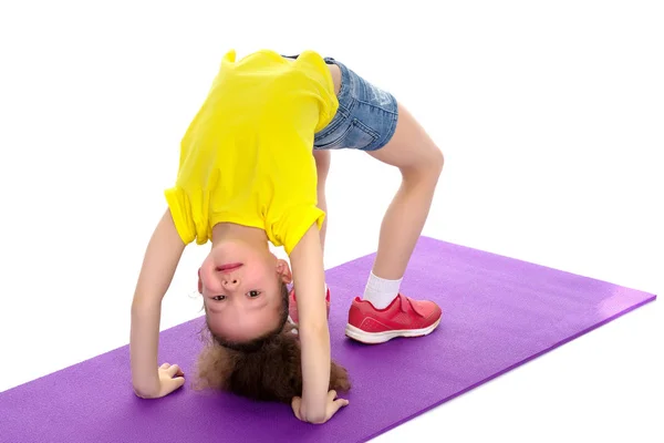 The little gymnast perform an acrobatic element on the floor. — Stock Photo, Image