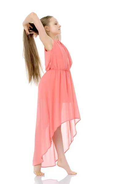 A little girl fixes her hair. — Stock Photo, Image