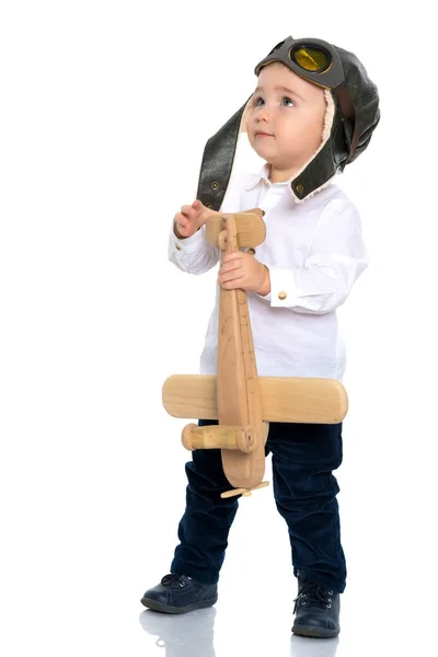 Little boy with a wooden plane. — Stock Photo, Image