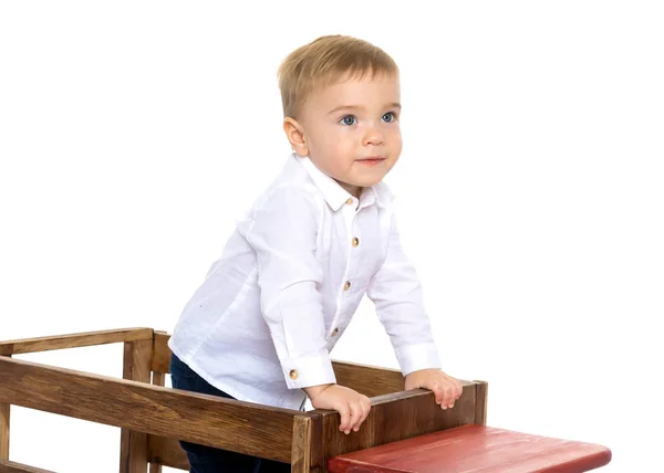 A little boy is playing with a toy car. — Stock Photo, Image