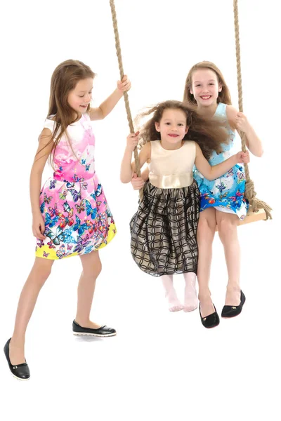 Joyful children swing on a swing. — Stock Photo, Image