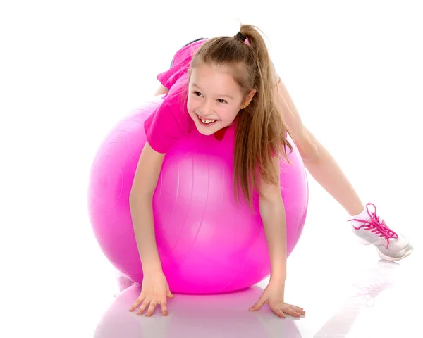 Little girl doing exercises on a big ball for fitness. — Stock Photo, Image