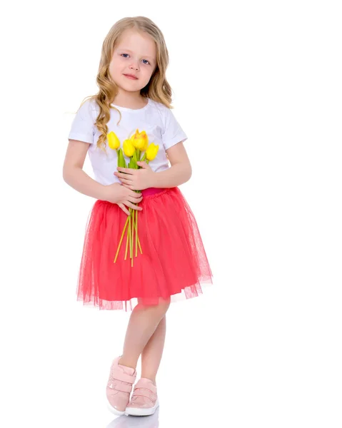 Little girl with a bouquet of tulips. — Stock Photo, Image