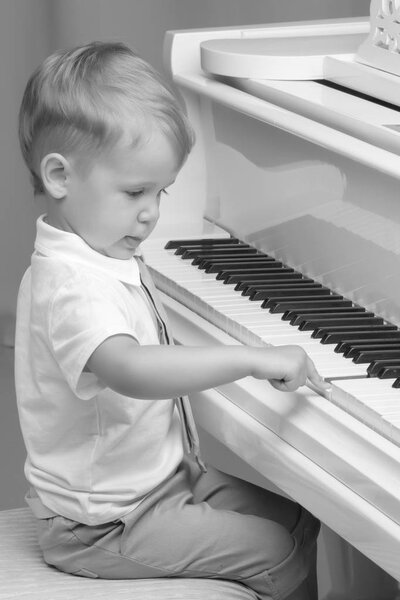Little boy playing piano at home. Concept of music 