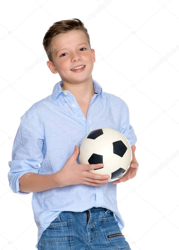 Boy teenager with a soccer ball.