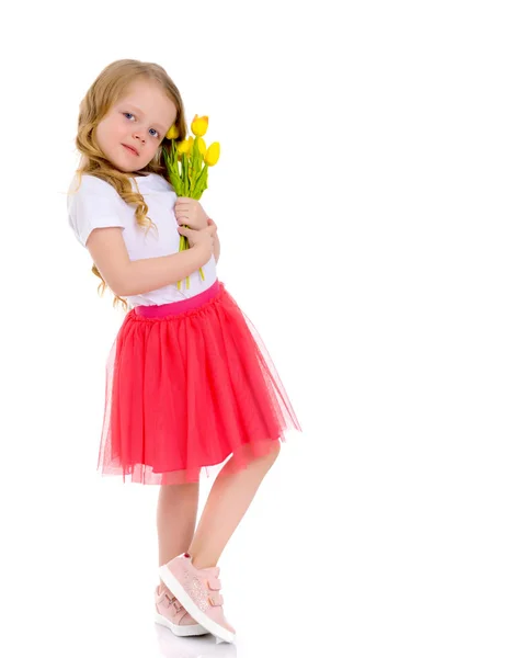 Petite fille avec un bouquet de tulipes . — Photo