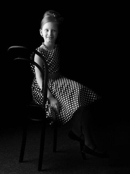 Little girl on a black background