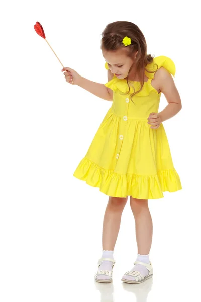 Little girl with a candy on a stick — Stock Photo, Image