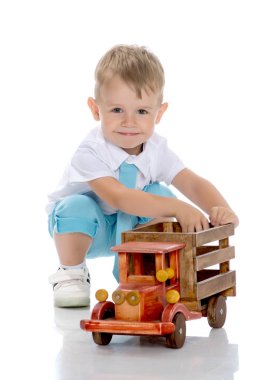 Küçük bir çocuk oyuncak bir arabayla oynuyor..