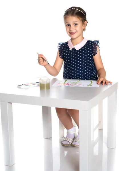 Маленька дівчинка малює фарбою і пензлем . — стокове фото