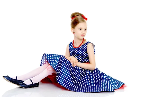Little girl is sitting on the floor. Stock Picture