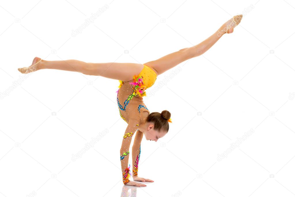 The gymnast perform an acrobatic element on the floor.