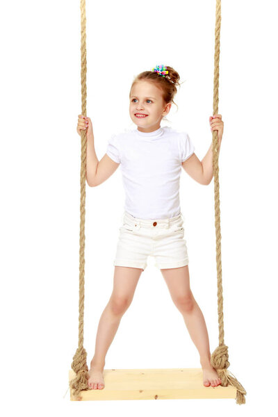 Little girl swinging on a swing