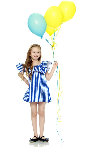 Adorable little blond girl in very short summer striped dress. — Stock Photo, Image