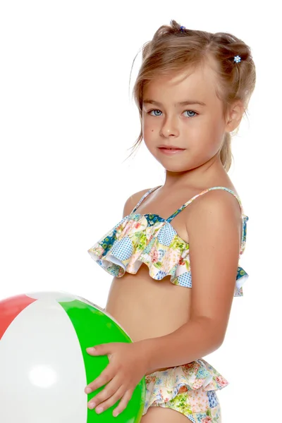 Little girl in a swimsuit with a ball — Stock Photo, Image