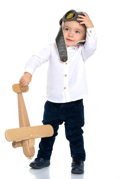 Little boy with a wooden plane. — Stock Photo, Image