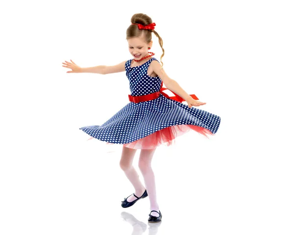 A little girl in a dress is spinning. — Stock Photo, Image